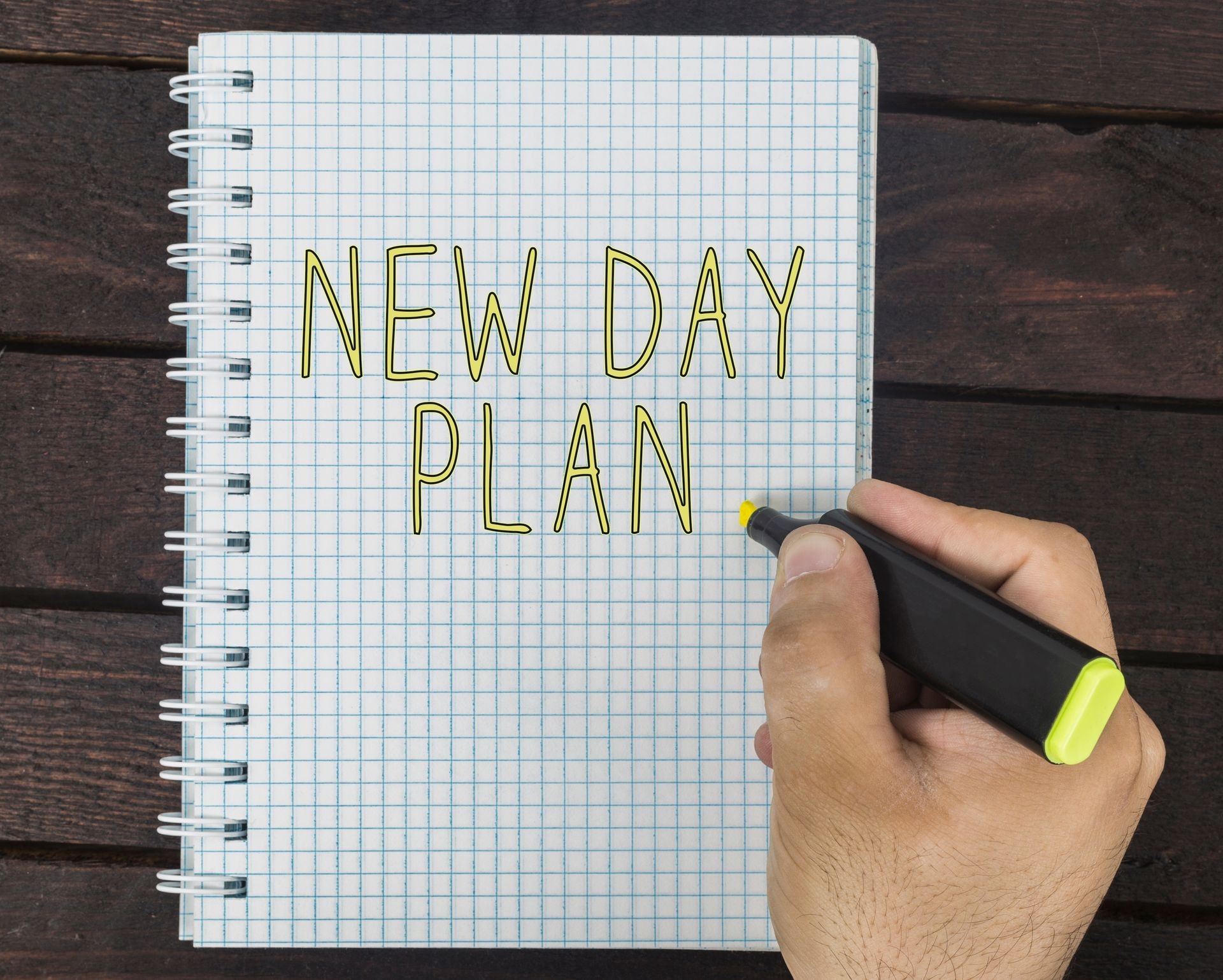 New day life concept. Hand writing New day plan on a notepad